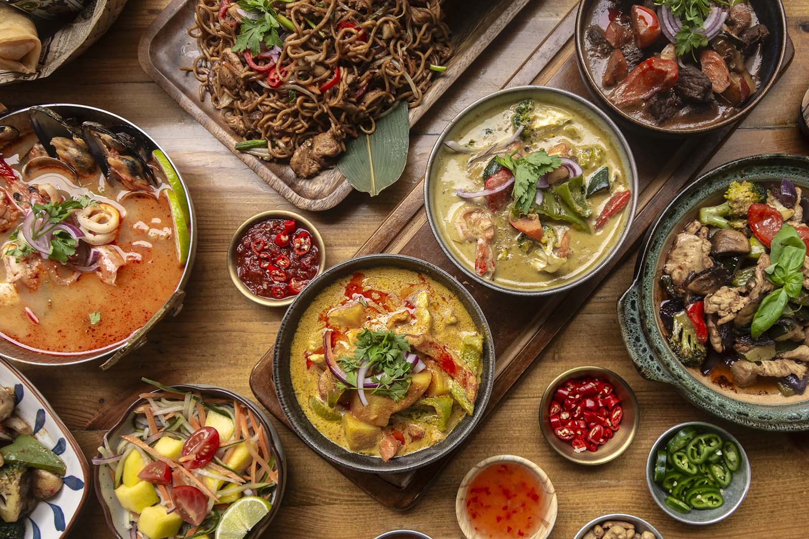 Evergreen Thai downtown group-friendly spread with curries noodles salad and stir-fry dishes arranged for sharing