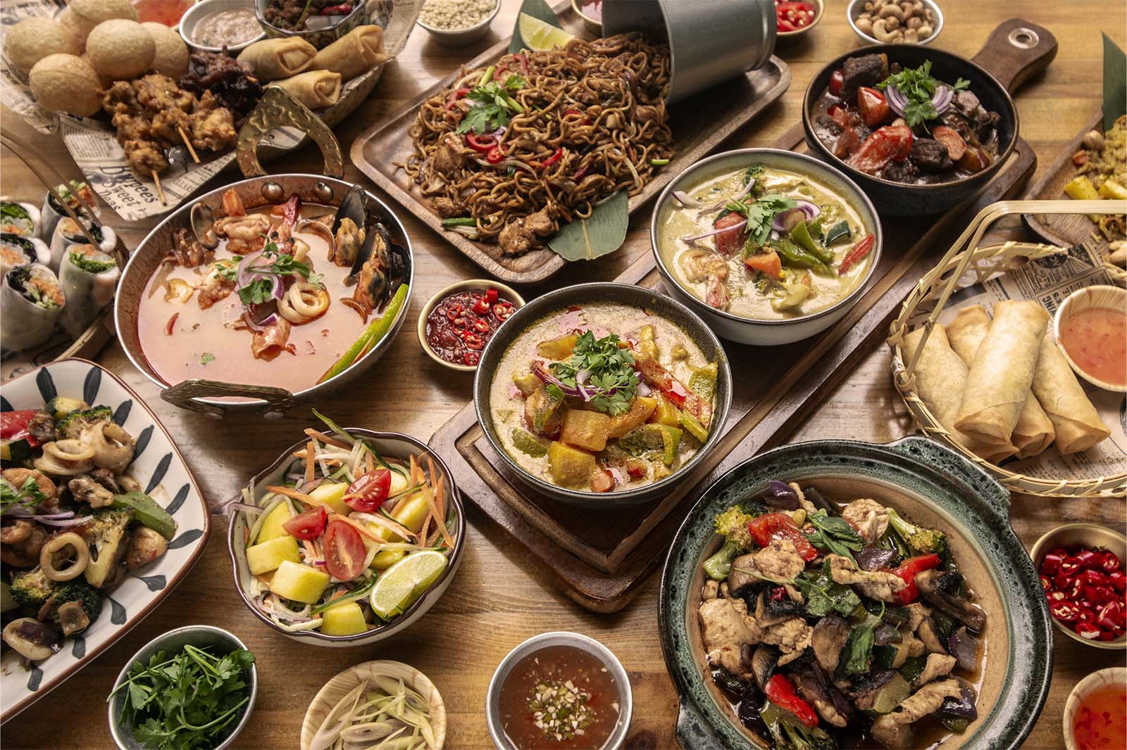 Evergreen Thai large shared order with noodles curries soup and spring rolls prepared for downtown Toronto delivery